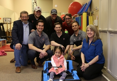 Group of people smiling with child